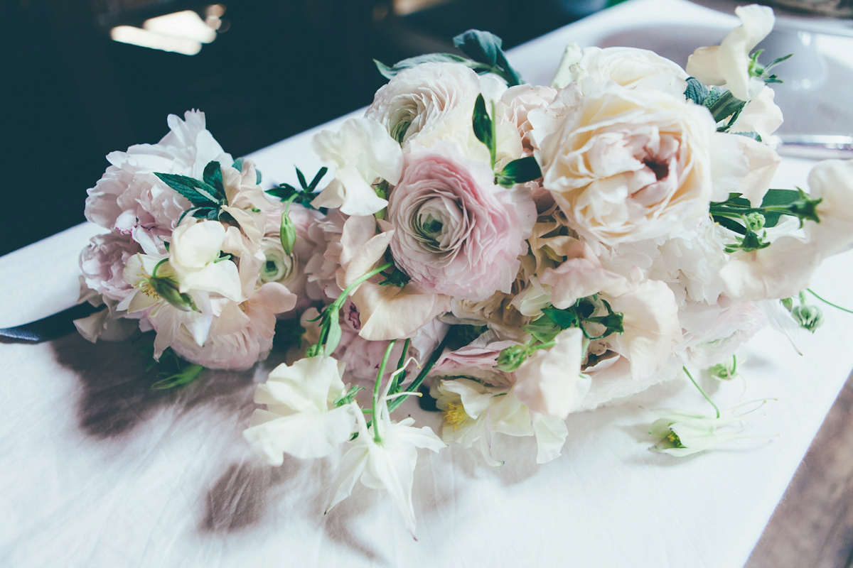 Ash wore a Jesus Peiro gown and winged shoes by Sophia Webster for her stripped back and fuss free wedding in London. Captured by September Pictures.