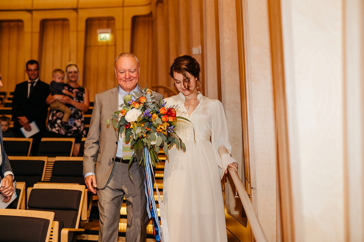 Jo wore the same dress her mother wore - a 1970's Ossie Clarke gown, for her colourful and modern wedding at the Royal Welsh College of Music. Photograhpy by Elaine Williams.