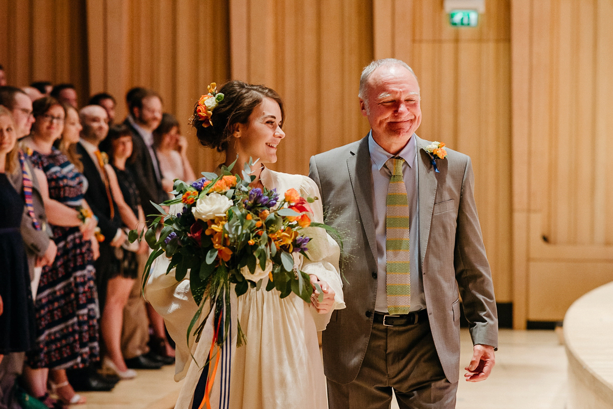 Jo wore the same dress her mother wore - a 1970's Ossie Clarke gown, for her colourful and modern wedding at the Royal Welsh College of Music. Photograhpy by Elaine Williams.