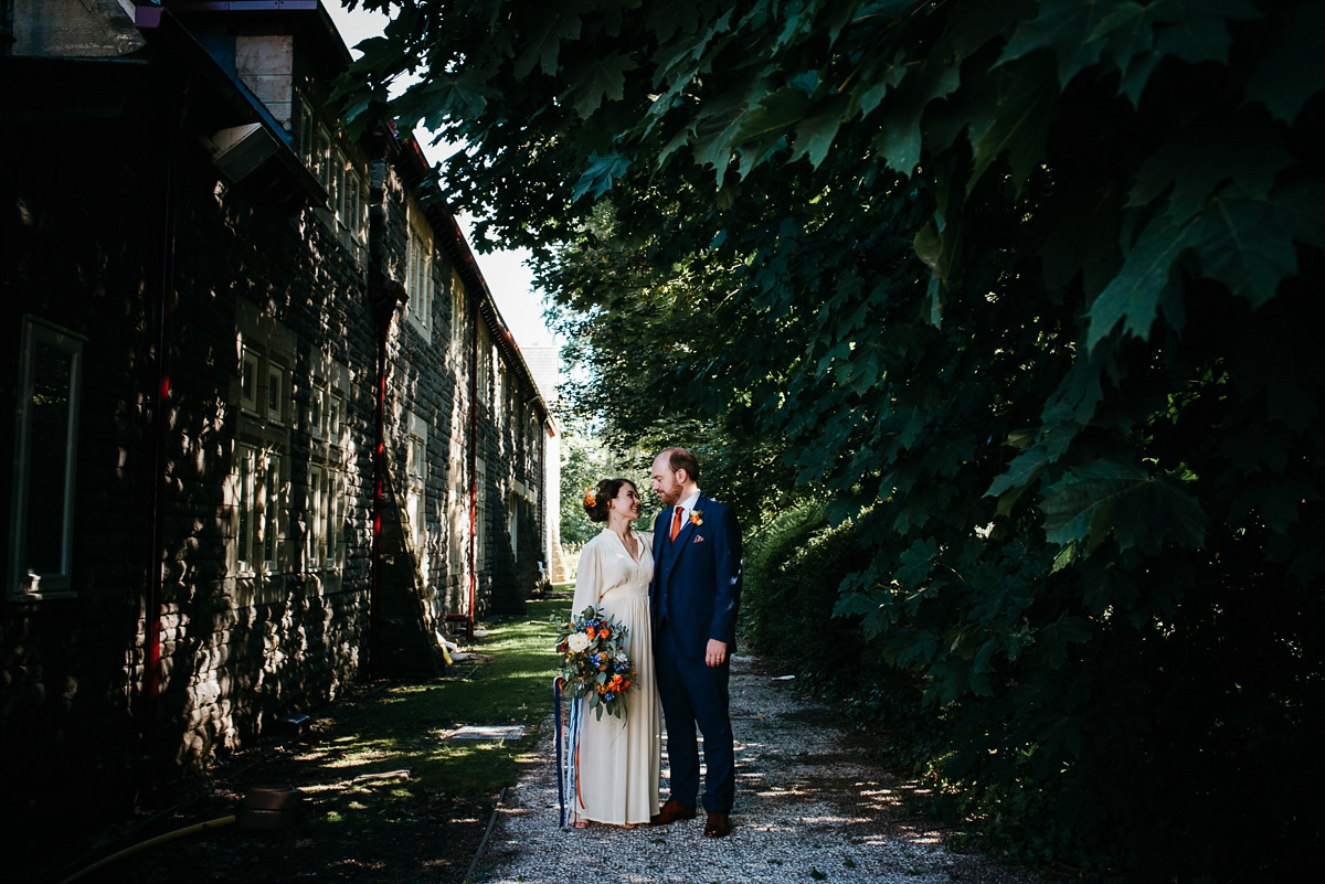 Jo wore the same dress her mother wore - a 1970's Ossie Clarke gown, for her colourful and modern wedding at the Royal Welsh College of Music. Photograhpy by Elaine Williams.