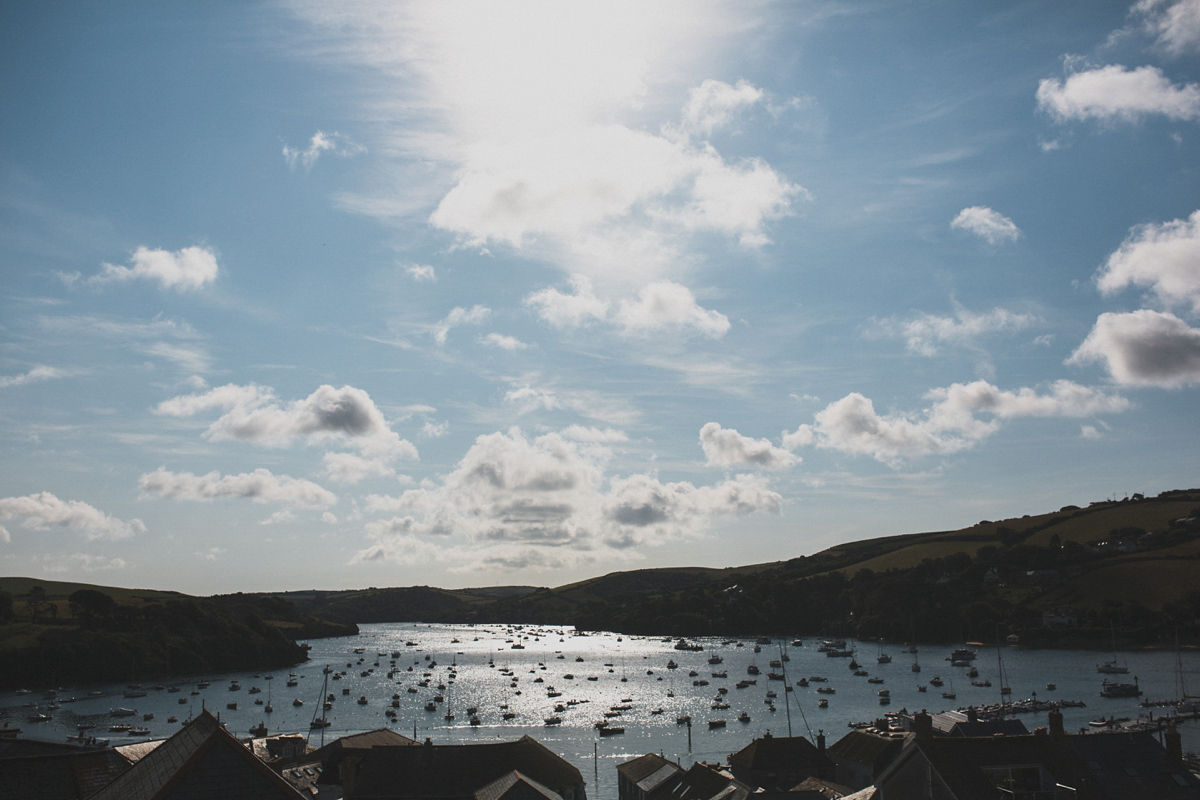 Rosie wore a Laure de Sagazan gown from The Mews of Notting Hill for her romantic summertime Devonshire coast wedding. Photography by Joseph Hall.