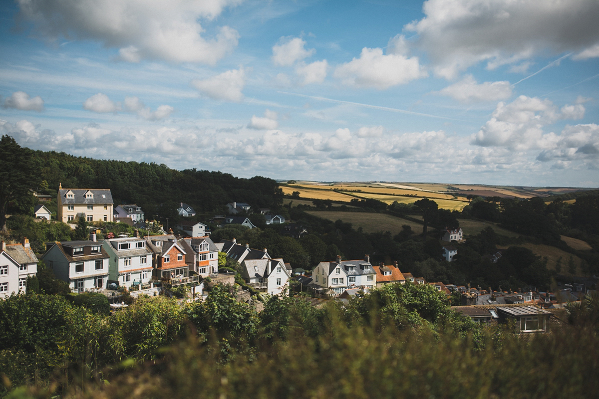 Rosie wore a Laure de Sagazan gown from The Mews of Notting Hill for her romantic summertime Devonshire coast wedding. Photography by Joseph Hall.