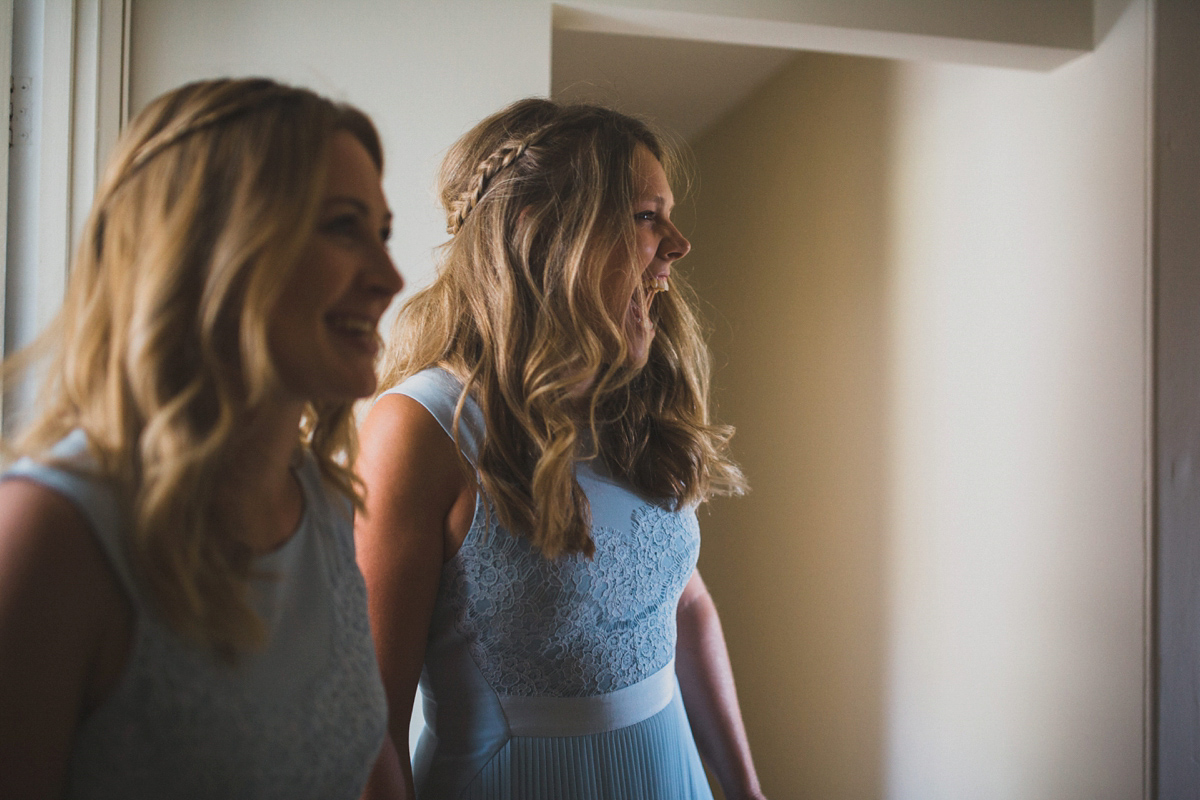 Rosie wore a Laure de Sagazan gown from The Mews of Notting Hill for her romantic summertime Devonshire coast wedding. Photography by Joseph Hall.