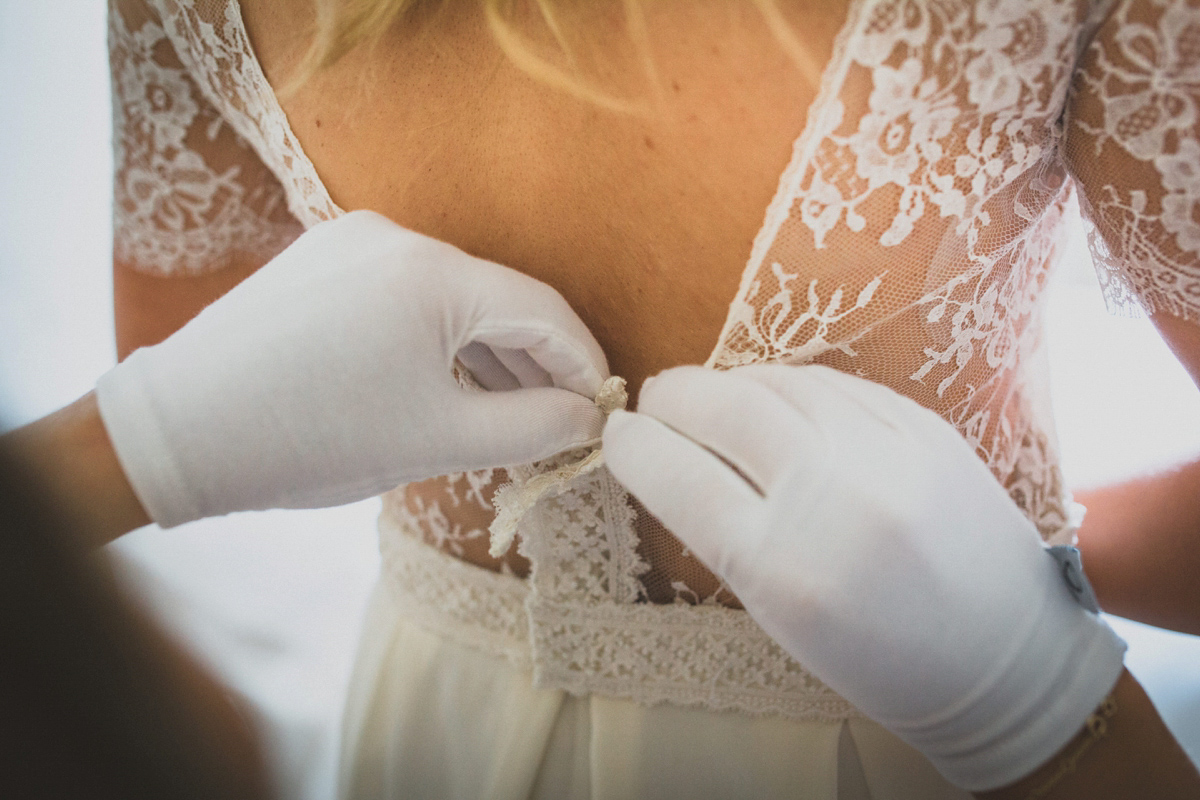 Rosie wore a Laure de Sagazan gown from The Mews of Notting Hill for her romantic summertime Devonshire coast wedding. Photography by Joseph Hall.