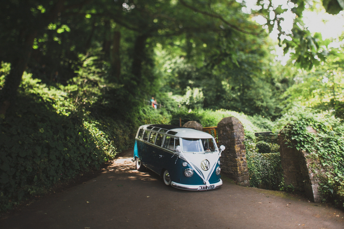 Rosie wore a Laure de Sagazan gown from The Mews of Notting Hill for her romantic summertime Devonshire coast wedding. Photography by Joseph Hall.