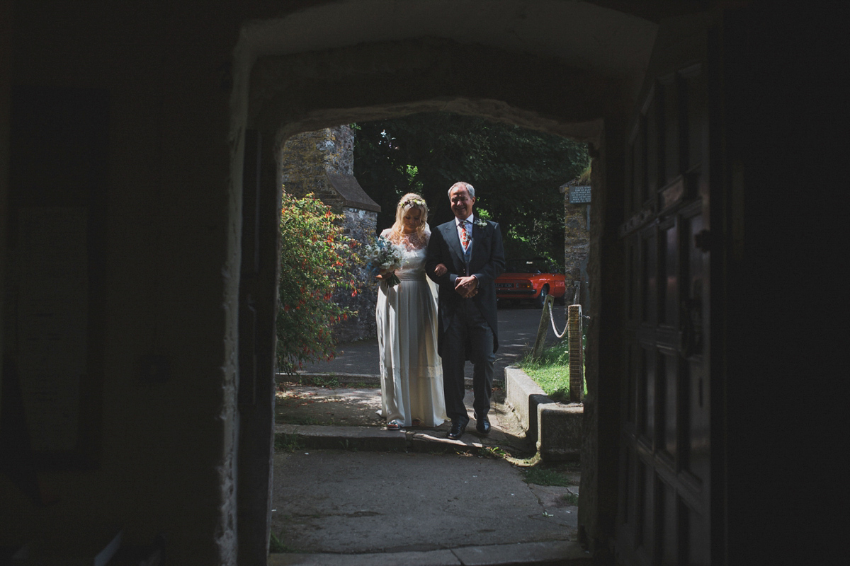 Rosie wore a Laure de Sagazan gown from The Mews of Notting Hill for her romantic summertime Devonshire coast wedding. Photography by Joseph Hall.