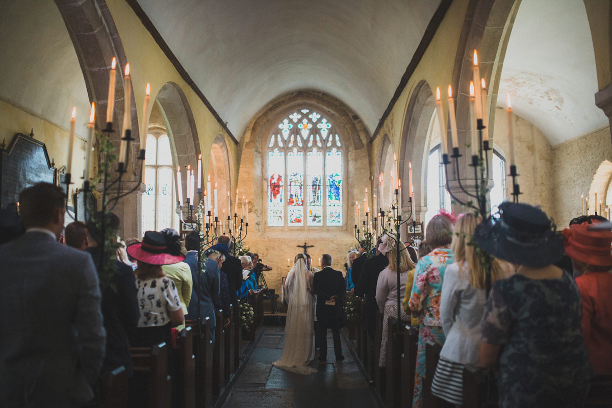 Rosie wore a Laure de Sagazan gown from The Mews of Notting Hill for her romantic summertime Devonshire coast wedding. Photography by Joseph Hall.