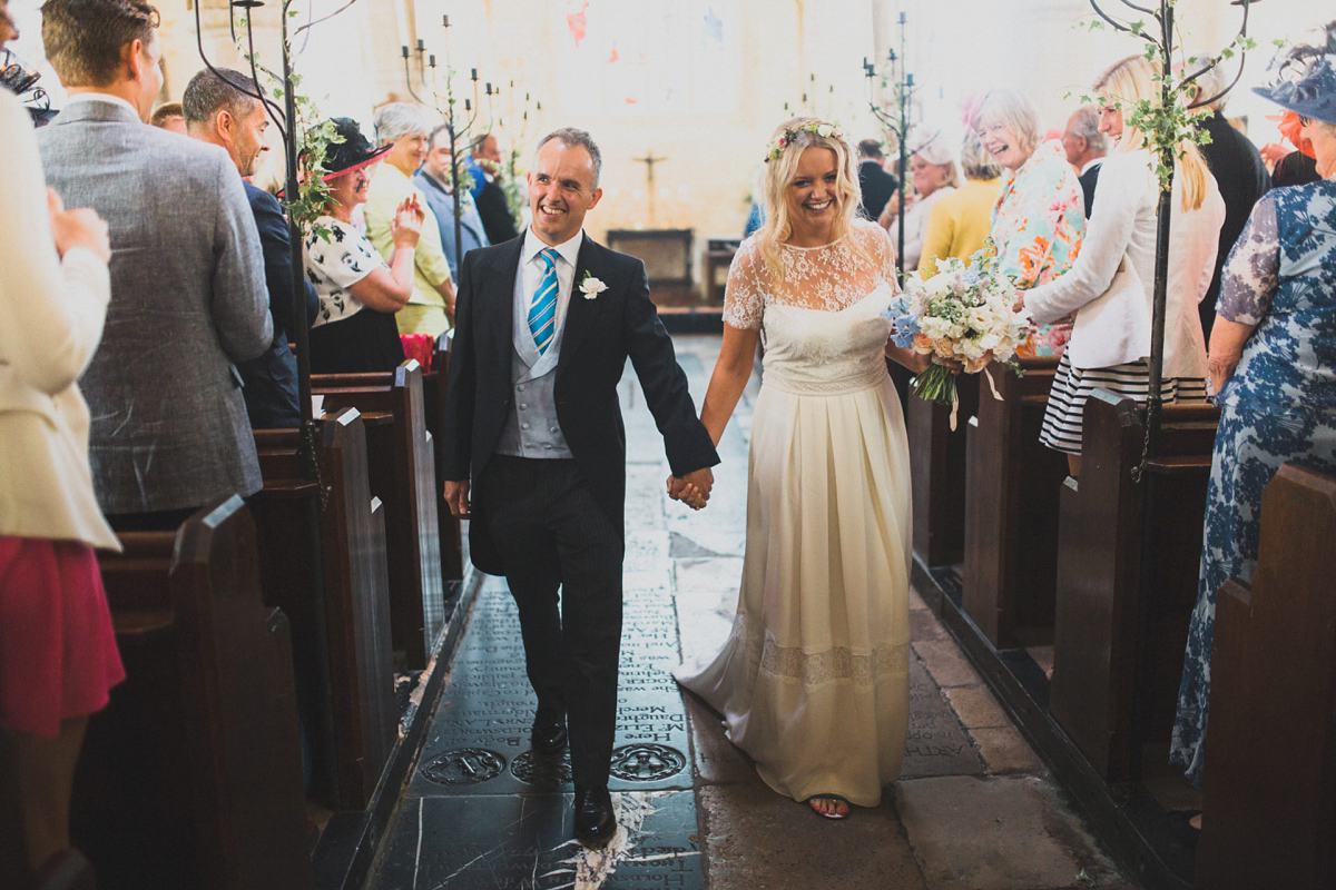 Rosie wore a Laure de Sagazan gown from The Mews of Notting Hill for her romantic summertime Devonshire coast wedding. Photography by Joseph Hall.