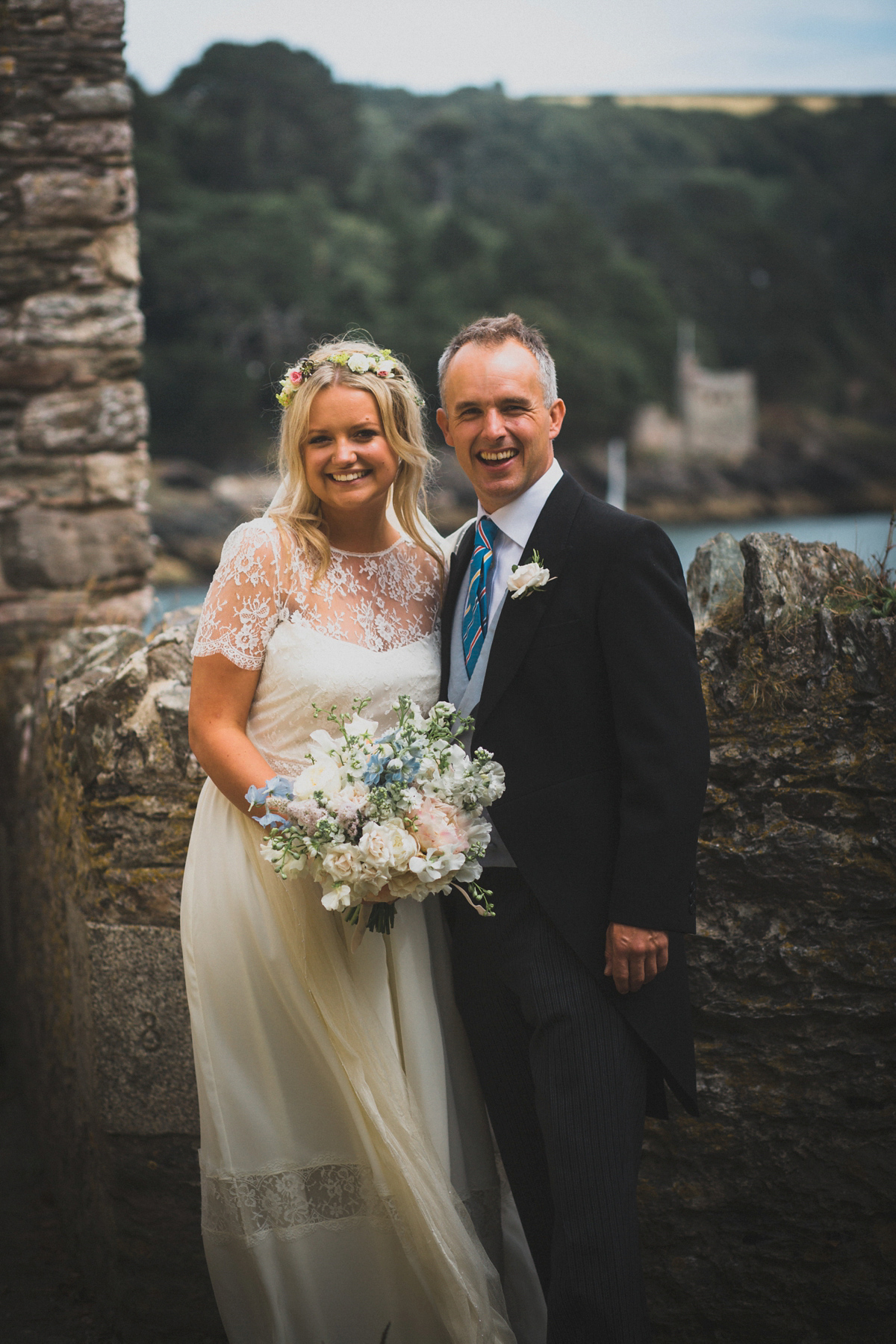 Rosie wore a Laure de Sagazan gown from The Mews of Notting Hill for her romantic summertime Devonshire coast wedding. Photography by Joseph Hall.