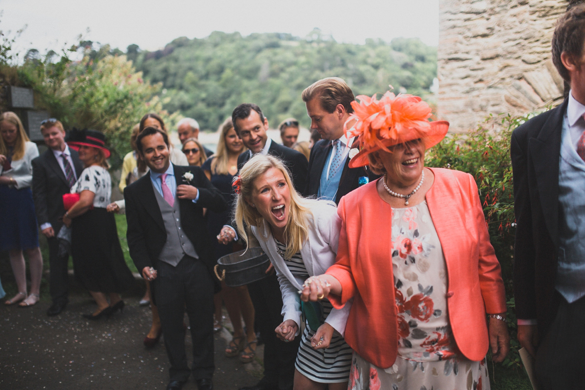 Rosie wore a Laure de Sagazan gown from The Mews of Notting Hill for her romantic summertime Devonshire coast wedding. Photography by Joseph Hall.