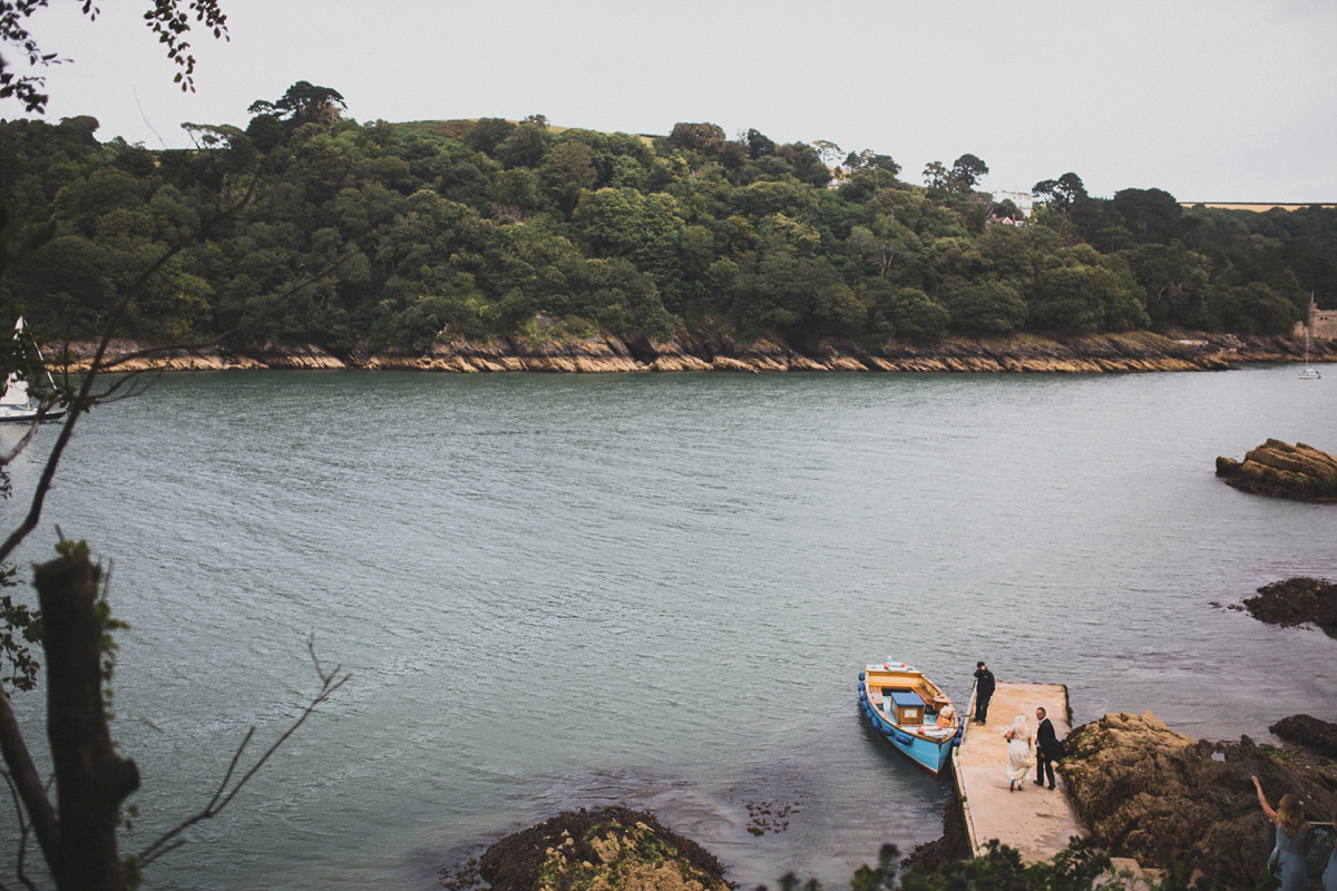 Rosie wore a Laure de Sagazan gown from The Mews of Notting Hill for her romantic summertime Devonshire coast wedding. Photography by Joseph Hall.