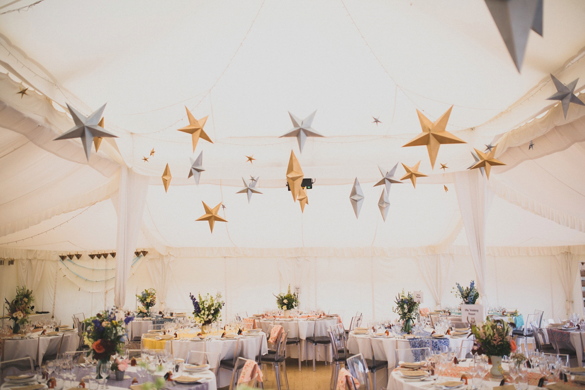 Rosie wore a Laure de Sagazan gown from The Mews of Notting Hill for her romantic summertime Devonshire coast wedding. Photography by Joseph Hall.