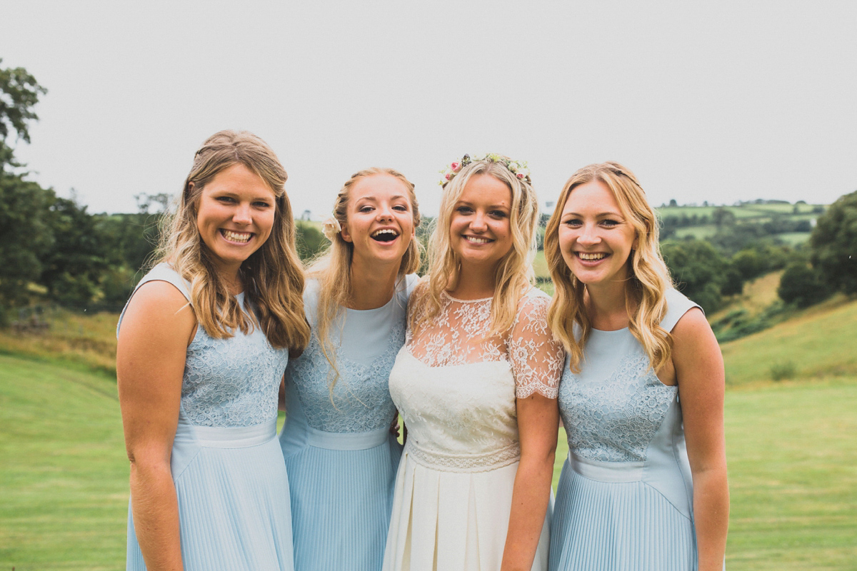 Rosie wore a Laure de Sagazan gown from The Mews of Notting Hill for her romantic summertime Devonshire coast wedding. Photography by Joseph Hall.