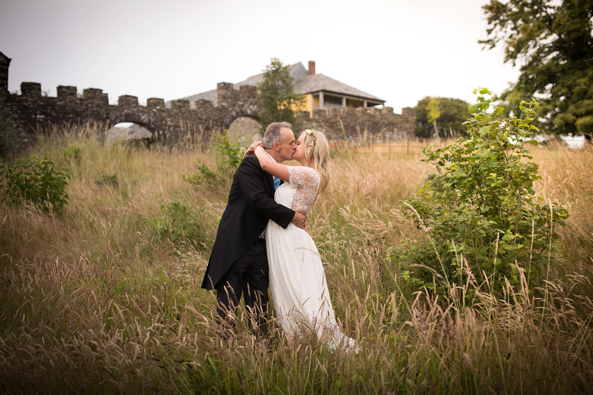 Rosie wore a Laure de Sagazan gown from The Mews of Notting Hill for her romantic summertime Devonshire coast wedding. Photography by Joseph Hall.