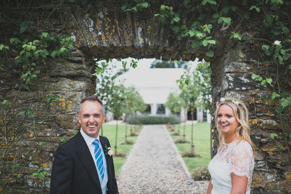 Rosie wore a Laure de Sagazan gown from The Mews of Notting Hill for her romantic summertime Devonshire coast wedding. Photography by Joseph Hall.