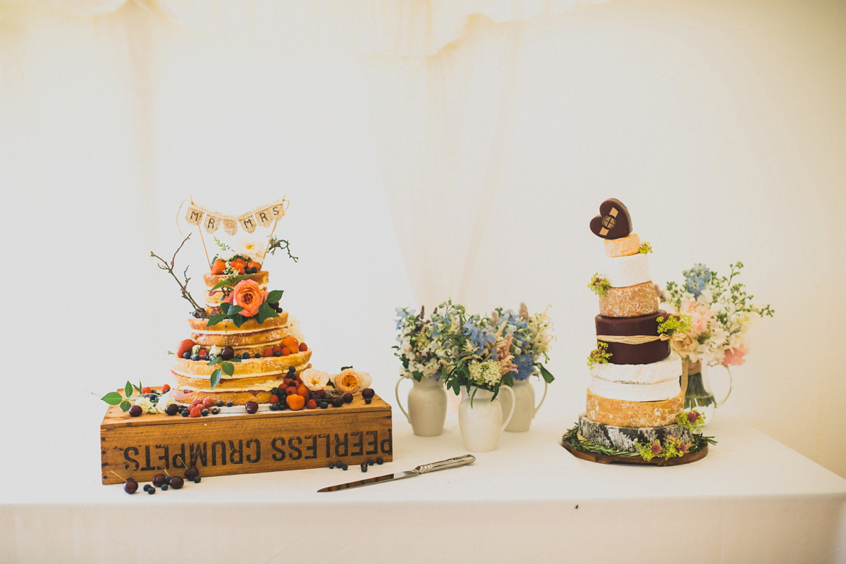 Rosie wore a Laure de Sagazan gown from The Mews of Notting Hill for her romantic summertime Devonshire coast wedding. Photography by Joseph Hall.