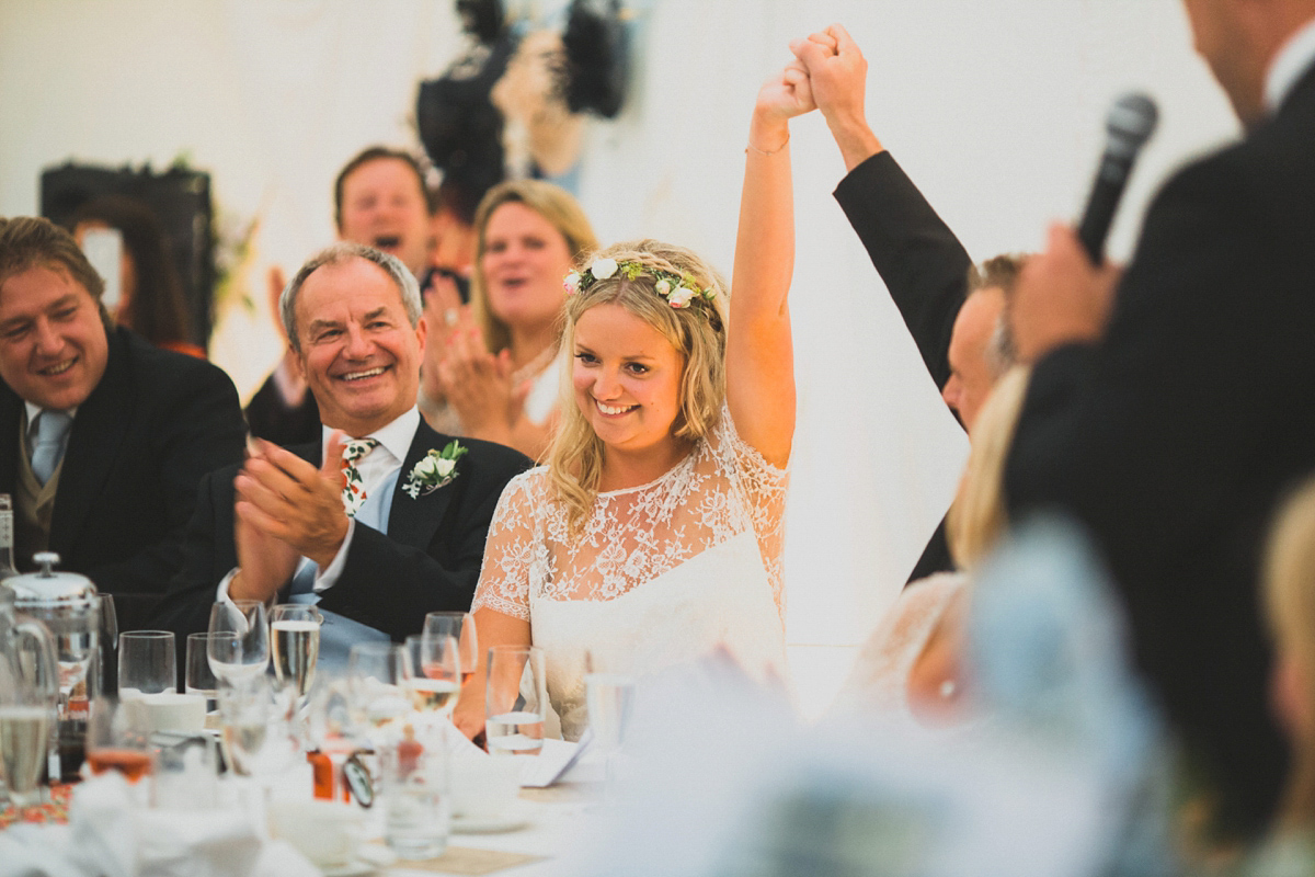 Rosie wore a Laure de Sagazan gown from The Mews of Notting Hill for her romantic summertime Devonshire coast wedding. Photography by Joseph Hall.