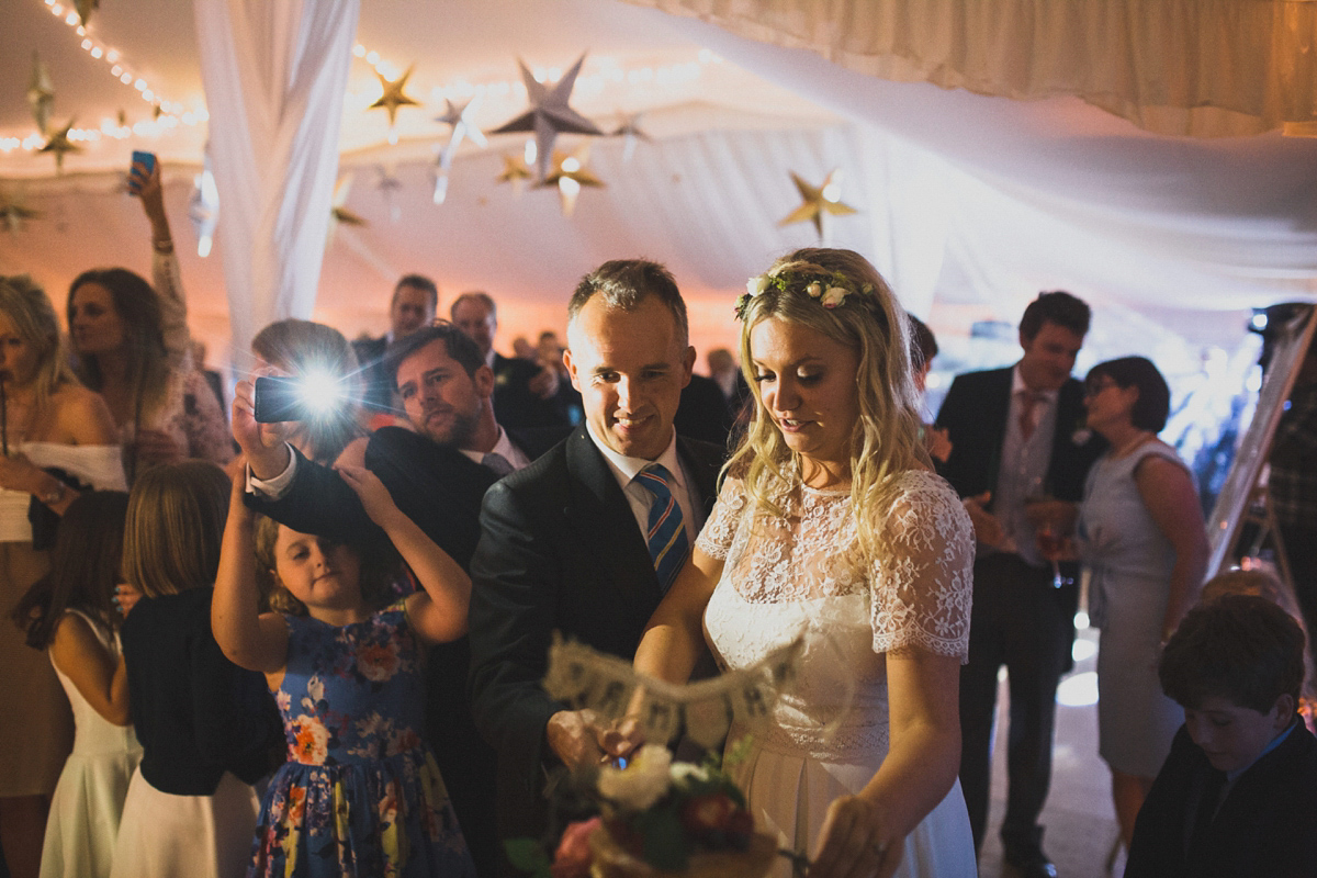 Rosie wore a Laure de Sagazan gown from The Mews of Notting Hill for her romantic summertime Devonshire coast wedding. Photography by Joseph Hall.