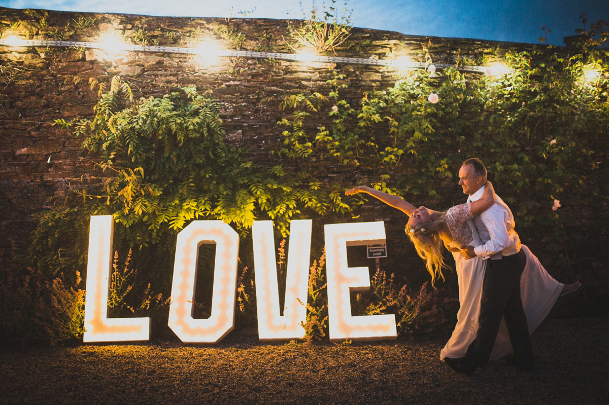 Rosie wore a Laure de Sagazan gown from The Mews of Notting Hill for her romantic summertime Devonshire coast wedding. Photography by Joseph Hall.