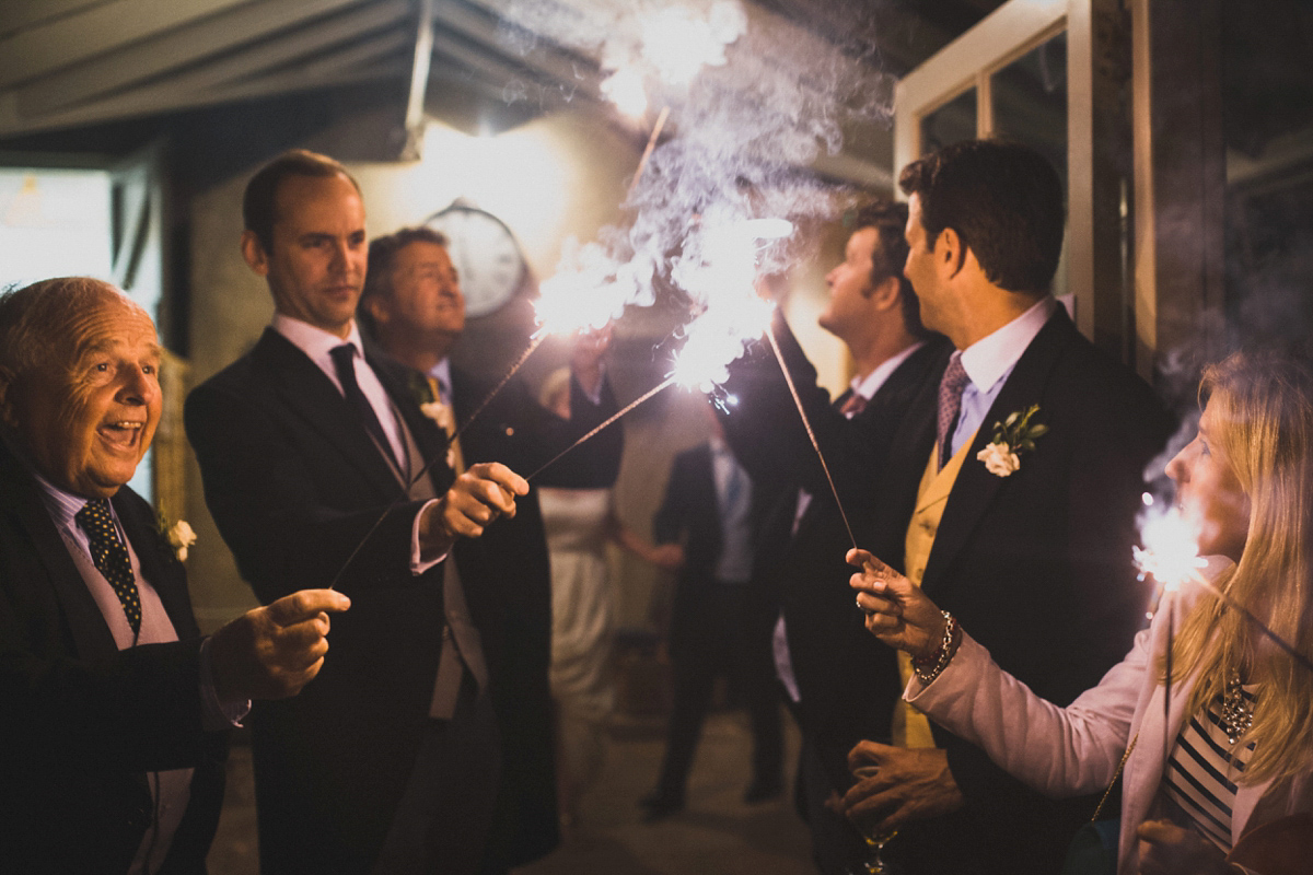 Rosie wore a Laure de Sagazan gown from The Mews of Notting Hill for her romantic summertime Devonshire coast wedding. Photography by Joseph Hall.