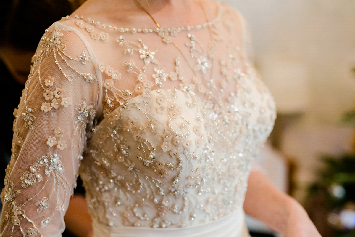 Katy wore a gold embroidered gown by Ronald Joyce for her glamorous winter wedding at Bath Assembly Rooms. Her bridesmaids wore navy blue. Photography by Lydia Stamps.