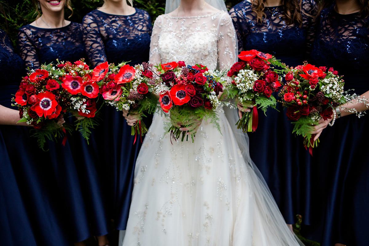 Katy wore a gold embroidered gown by Ronald Joyce for her glamorous winter wedding at Bath Assembly Rooms. Her bridesmaids wore navy blue. Photography by Lydia Stamps.