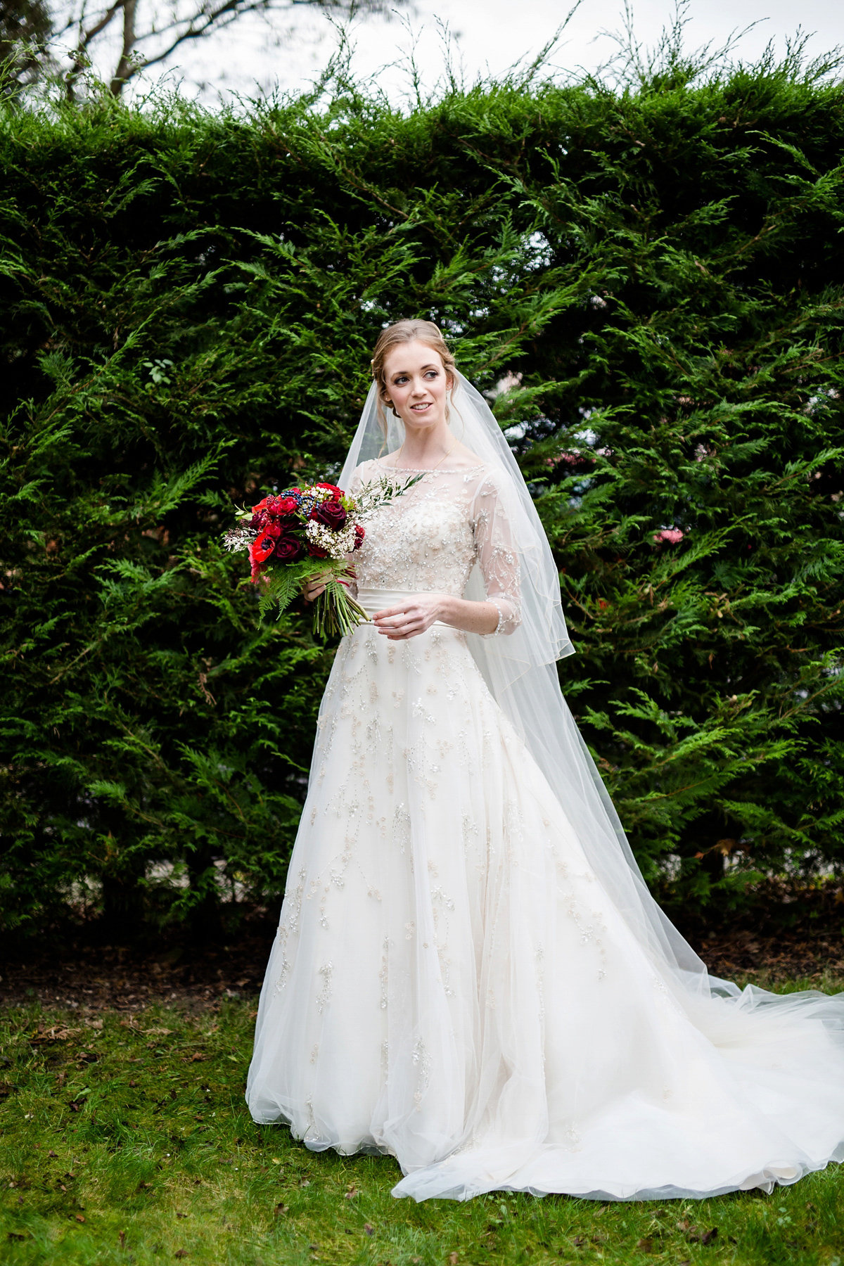 Katy wore a gold embroidered gown by Ronald Joyce for her glamorous winter wedding at Bath Assembly Rooms. Her bridesmaids wore navy blue. Photography by Lydia Stamps.