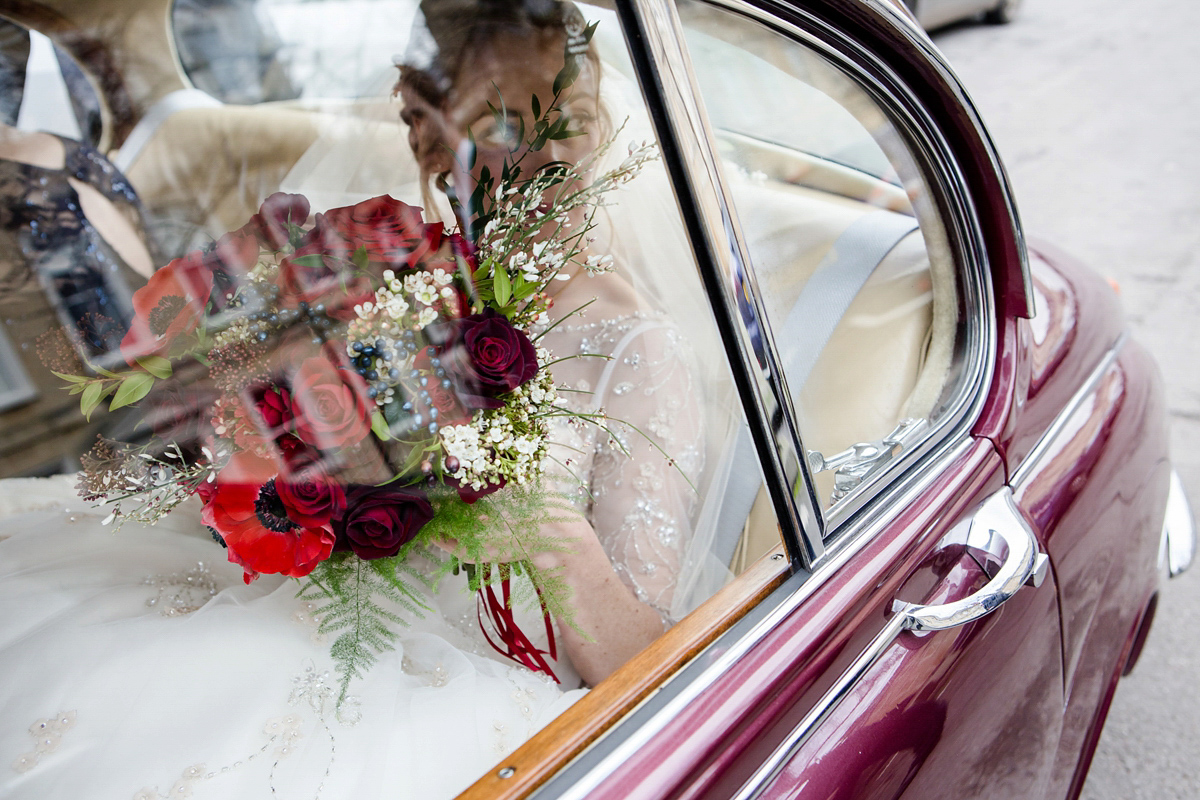 Katy wore a gold embroidered gown by Ronald Joyce for her glamorous winter wedding at Bath Assembly Rooms. Her bridesmaids wore navy blue. Photography by Lydia Stamps.