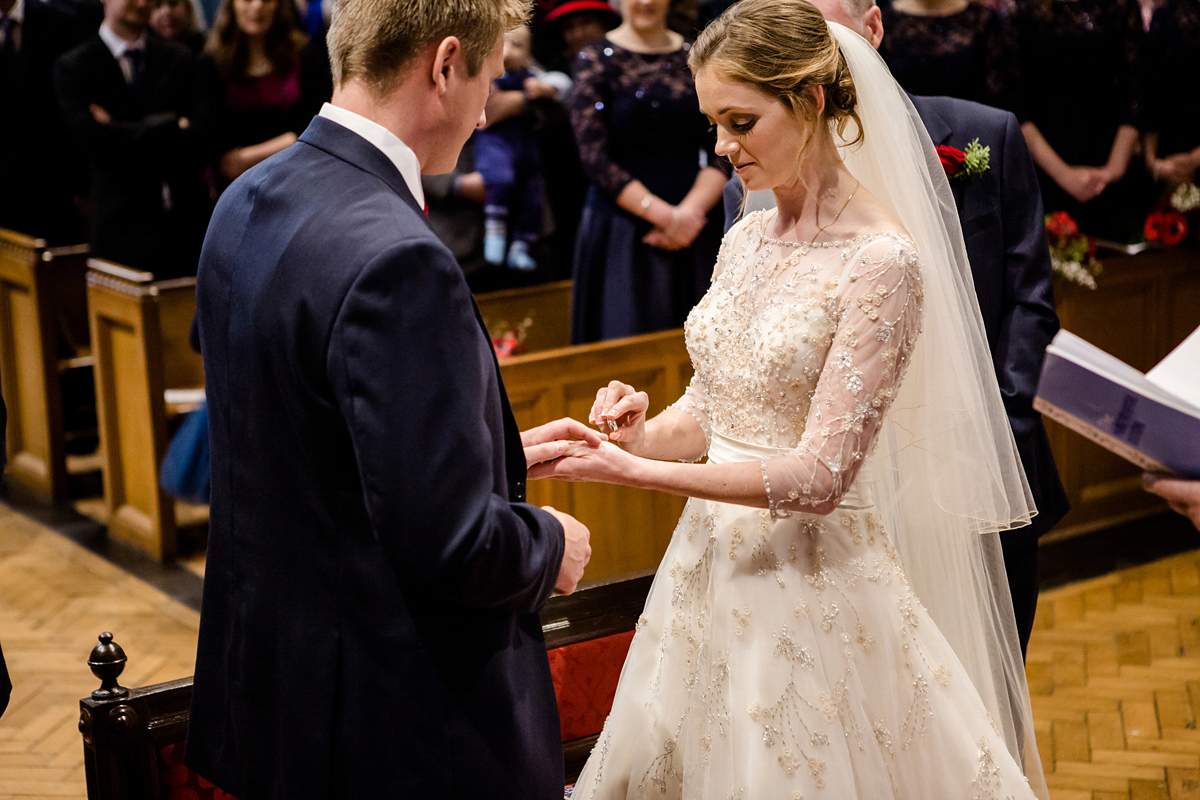 Katy wore a gold embroidered gown by Ronald Joyce for her glamorous winter wedding at Bath Assembly Rooms. Her bridesmaids wore navy blue. Photography by Lydia Stamps.