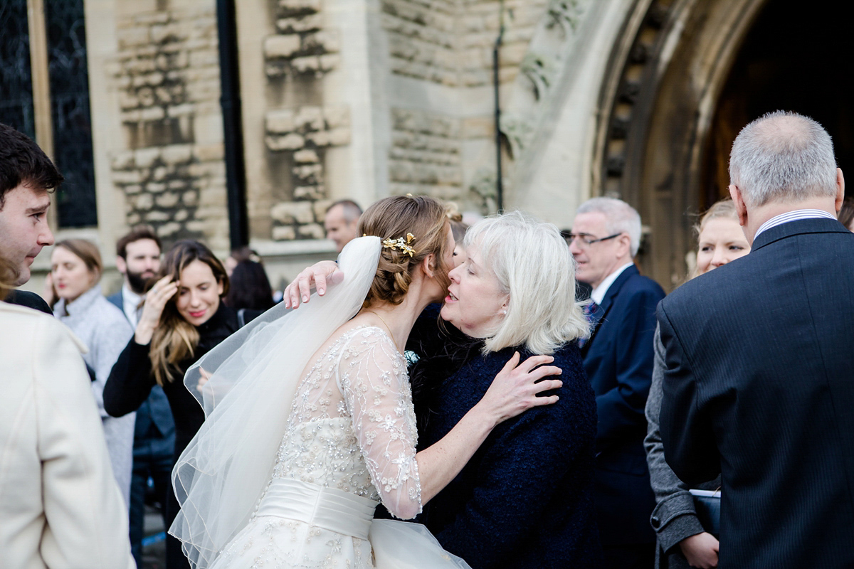 Katy wore a gold embroidered gown by Ronald Joyce for her glamorous winter wedding at Bath Assembly Rooms. Her bridesmaids wore navy blue. Photography by Lydia Stamps.