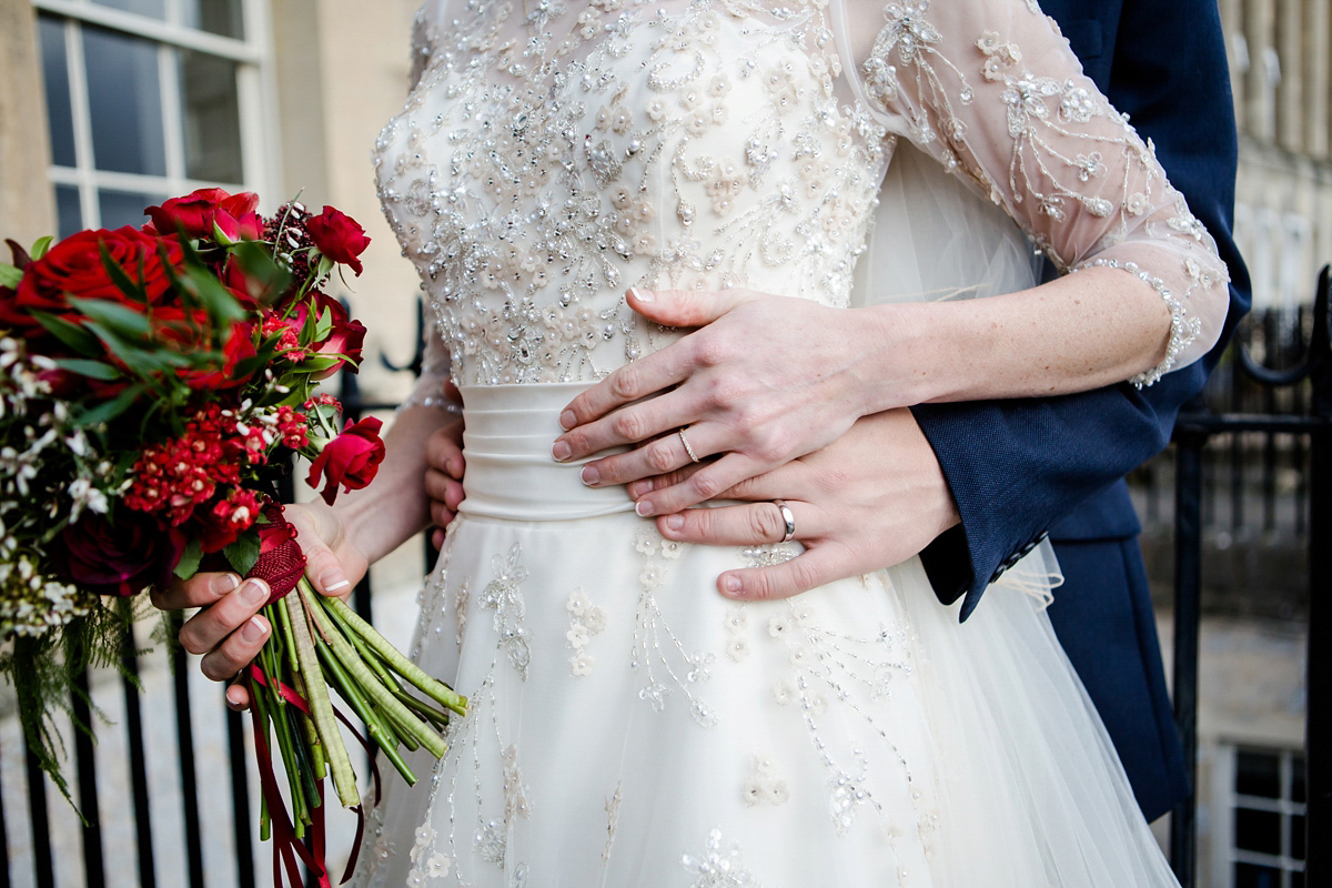 Katy wore a gold embroidered gown by Ronald Joyce for her glamorous winter wedding at Bath Assembly Rooms. Her bridesmaids wore navy blue. Photography by Lydia Stamps.