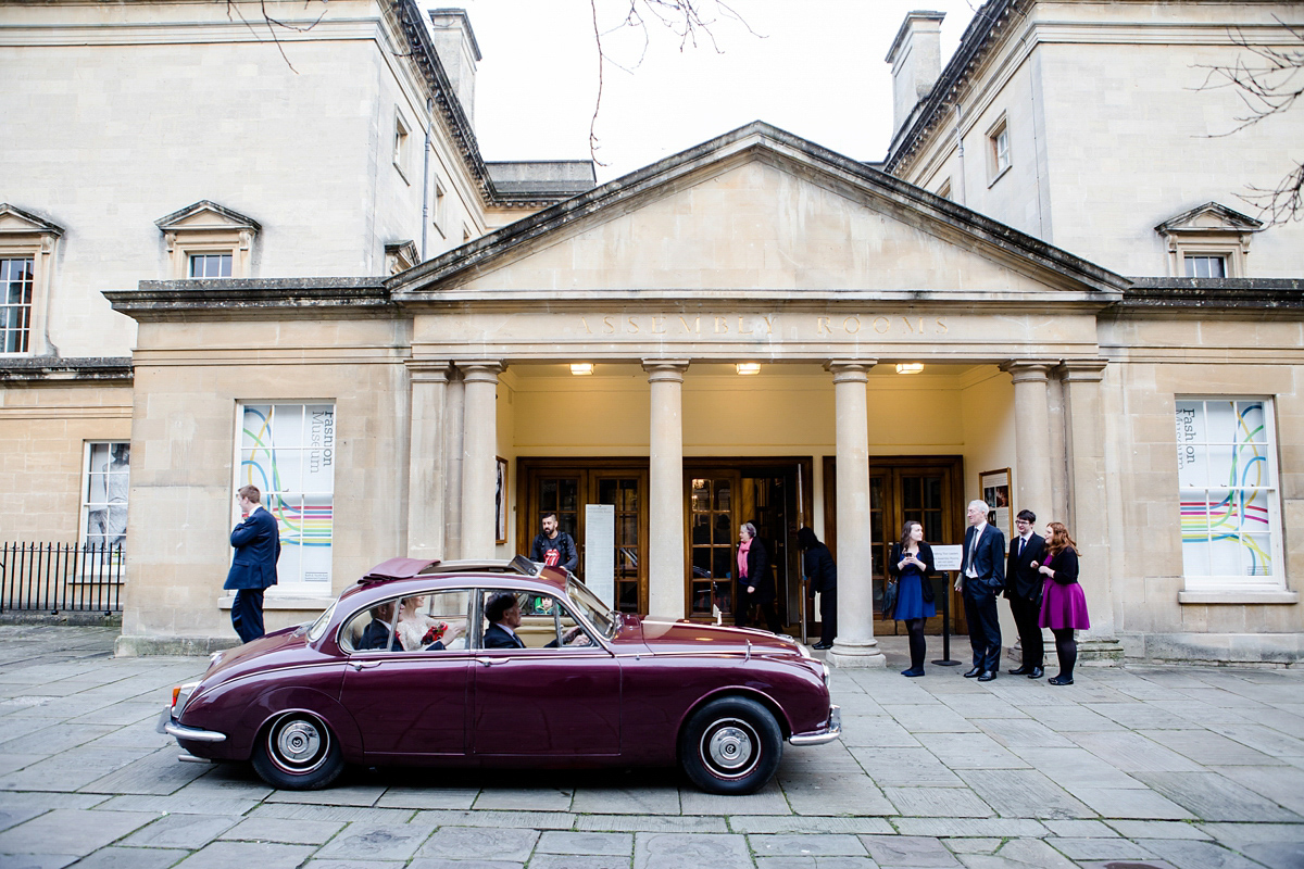 Katy wore a gold embroidered gown by Ronald Joyce for her glamorous winter wedding at Bath Assembly Rooms. Her bridesmaids wore navy blue. Photography by Lydia Stamps.