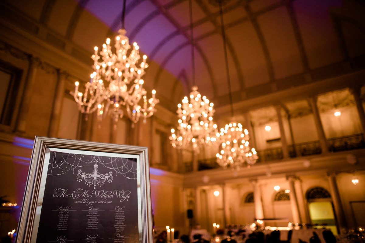 Katy wore a gold embroidered gown by Ronald Joyce for her glamorous winter wedding at Bath Assembly Rooms. Her bridesmaids wore navy blue. Photography by Lydia Stamps.