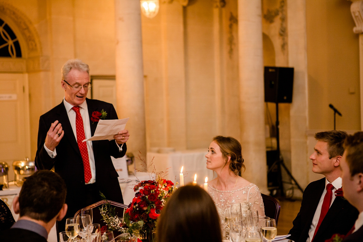 Katy wore a gold embroidered gown by Ronald Joyce for her glamorous winter wedding at Bath Assembly Rooms. Her bridesmaids wore navy blue. Photography by Lydia Stamps.