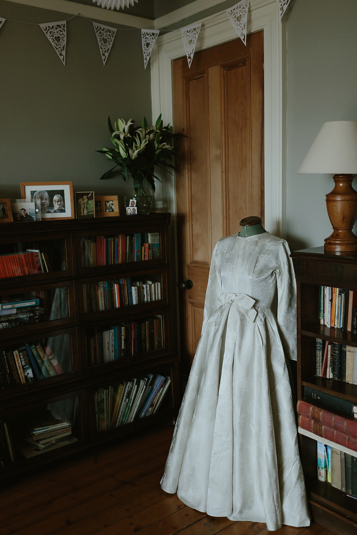 Berenice wore a 1930's vintage wedding dress for her intimate wedding held at home. The couple's ceremony involved a traditional Celtic handfasting. Photography by Rooftop Mosaic.