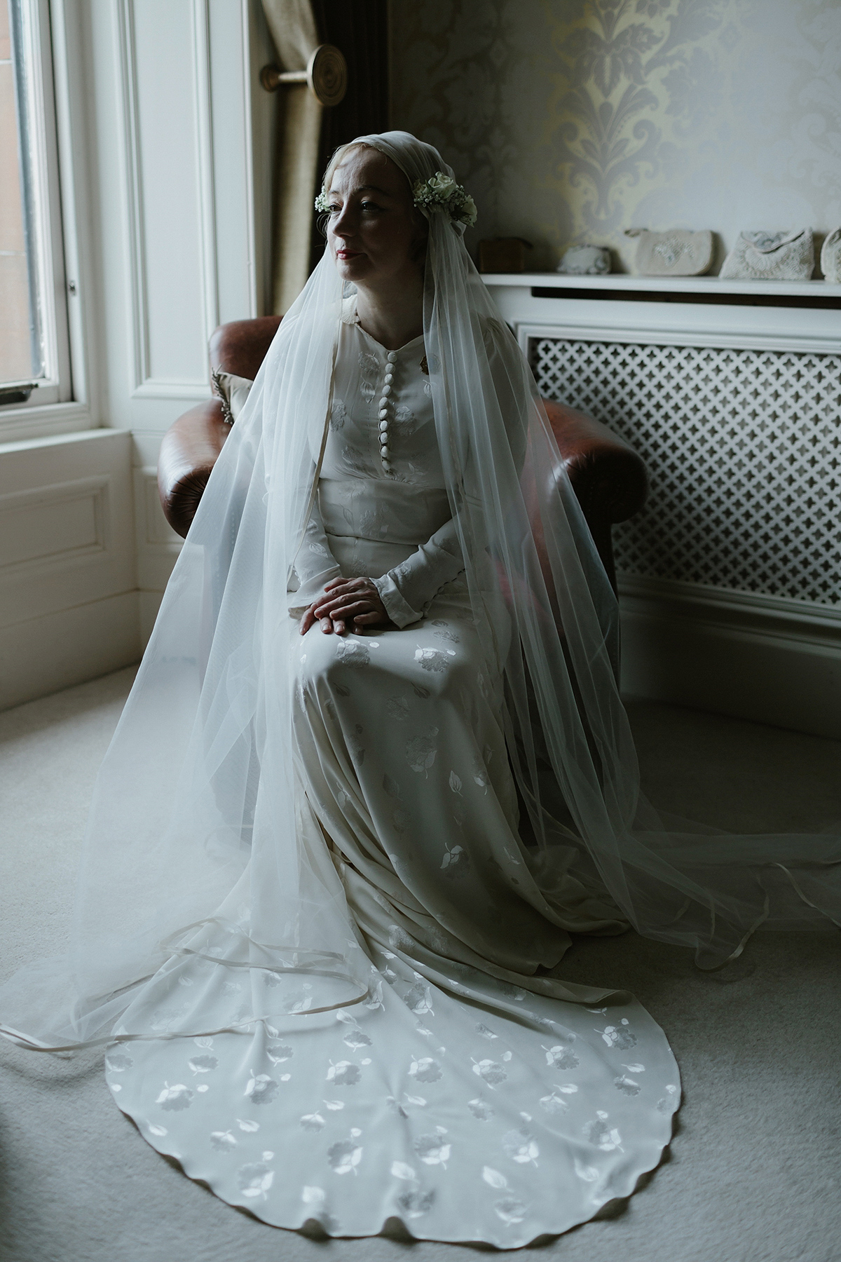 Berenice wore a 1930's vintage wedding dress for her intimate wedding held at home. The couple's ceremony involved a traditional Celtic handfasting. Photography by Rooftop Mosaic.