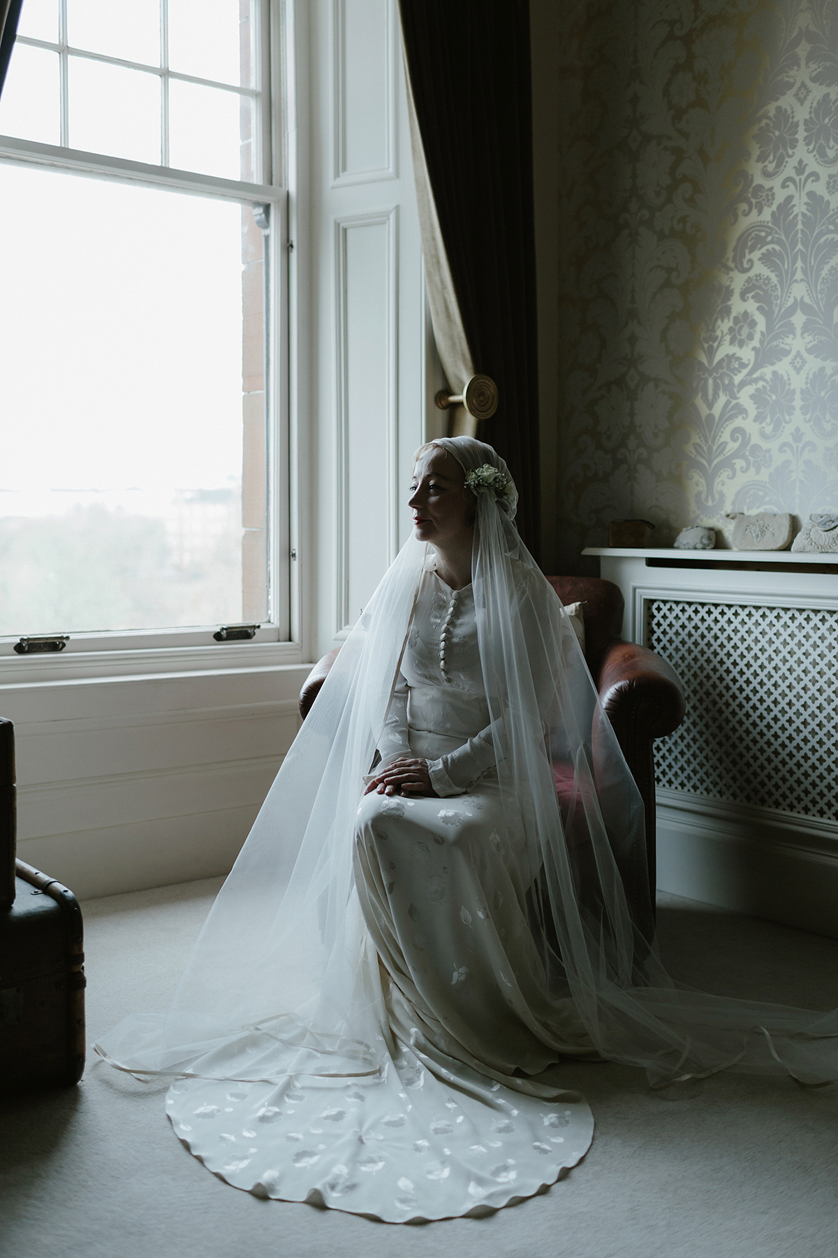 Berenice wore a 1930's vintage wedding dress for her intimate wedding held at home. The couple's ceremony involved a traditional Celtic handfasting. Photography by Rooftop Mosaic.