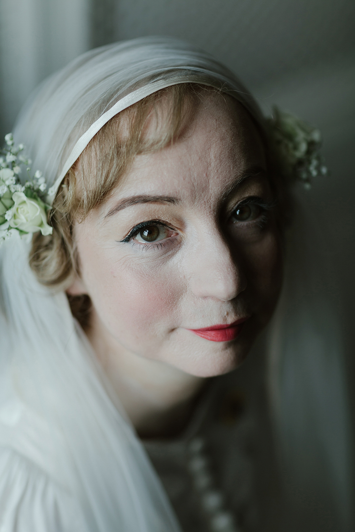 Berenice wore a 1930's vintage wedding dress for her intimate wedding held at home. The couple's ceremony involved a traditional Celtic handfasting. Photography by Rooftop Mosaic.