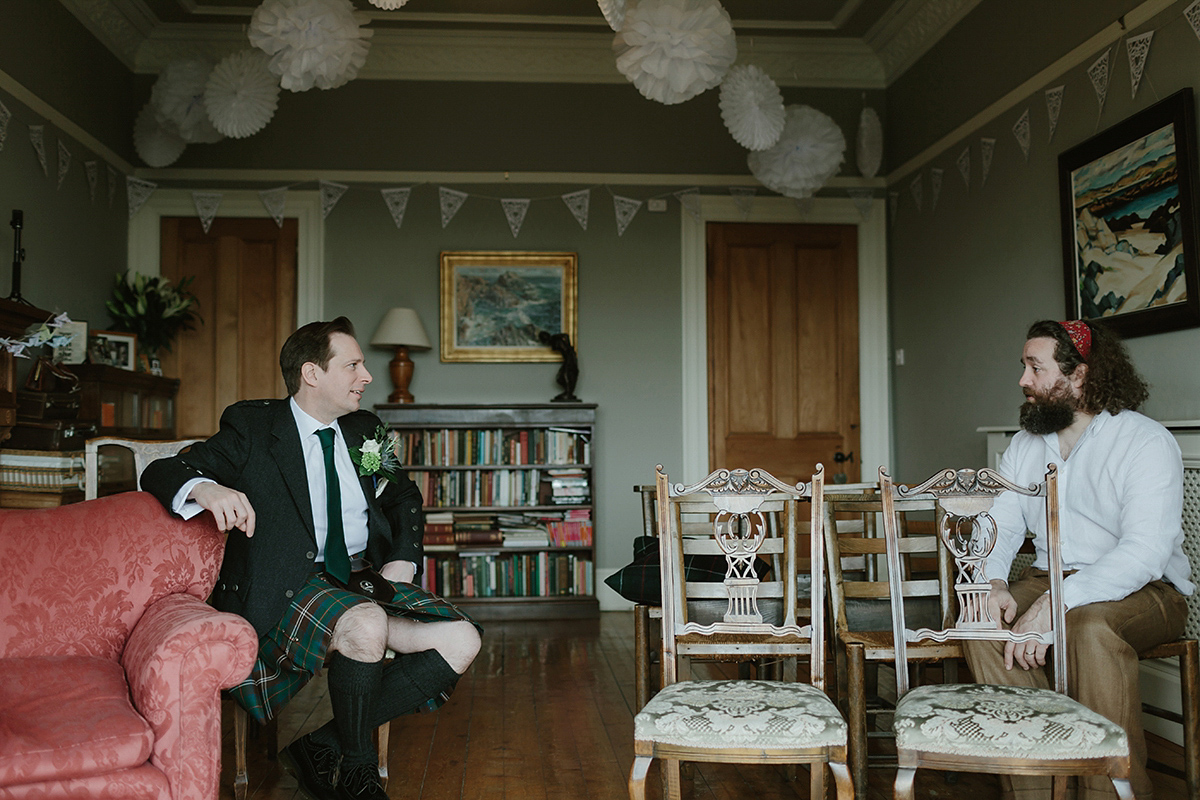 Berenice wore a 1930's vintage wedding dress for her intimate wedding held at home. The couple's ceremony involved a traditional Celtic handfasting. Photography by Rooftop Mosaic.