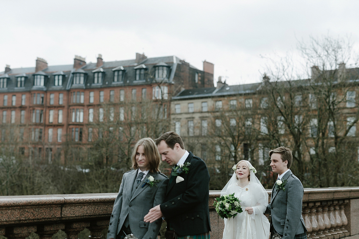 Berenice wore a 1930's vintage wedding dress for her intimate wedding held at home. The couple's ceremony involved a traditional Celtic handfasting. Photography by Rooftop Mosaic.