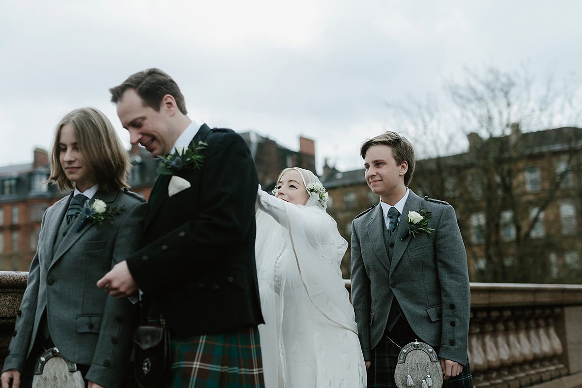 Berenice wore a 1930's vintage wedding dress for her intimate wedding held at home. The couple's ceremony involved a traditional Celtic handfasting. Photography by Rooftop Mosaic.