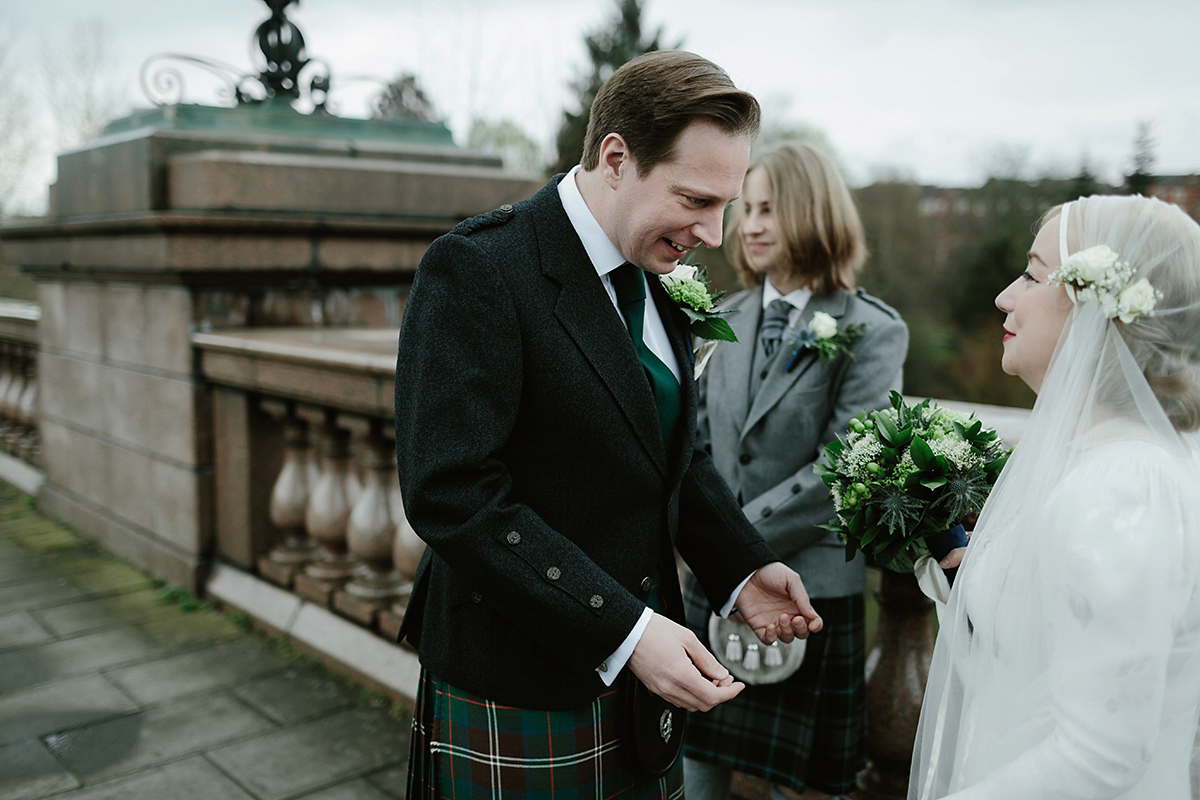 Berenice wore a 1930's vintage wedding dress for her intimate wedding held at home. The couple's ceremony involved a traditional Celtic handfasting. Photography by Rooftop Mosaic.