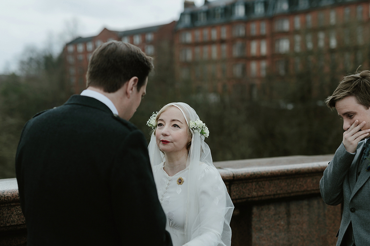 Berenice wore a 1930's vintage wedding dress for her intimate wedding held at home. The couple's ceremony involved a traditional Celtic handfasting. Photography by Rooftop Mosaic.