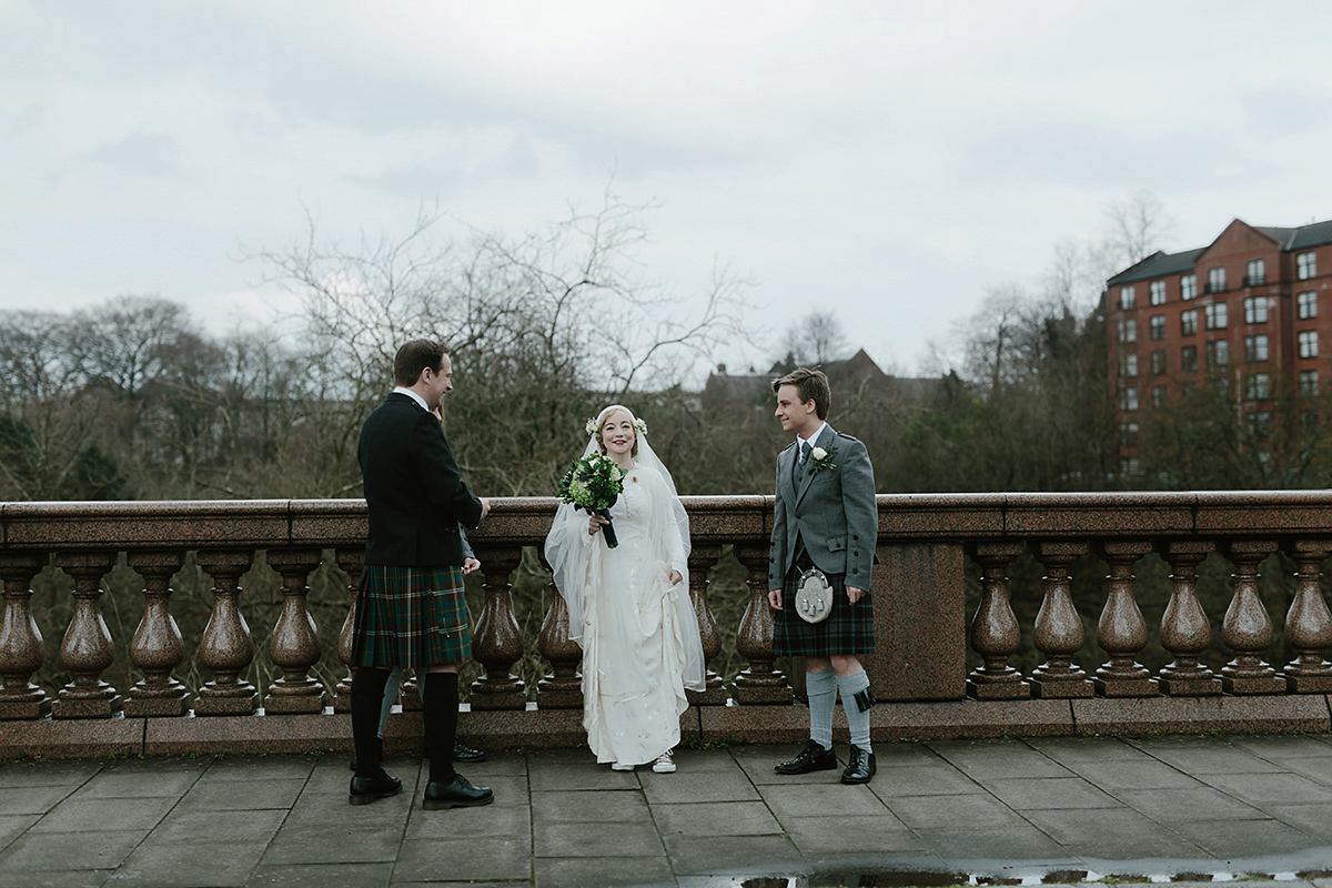 Berenice wore a 1930's vintage wedding dress for her intimate wedding held at home. The couple's ceremony involved a traditional Celtic handfasting. Photography by Rooftop Mosaic.