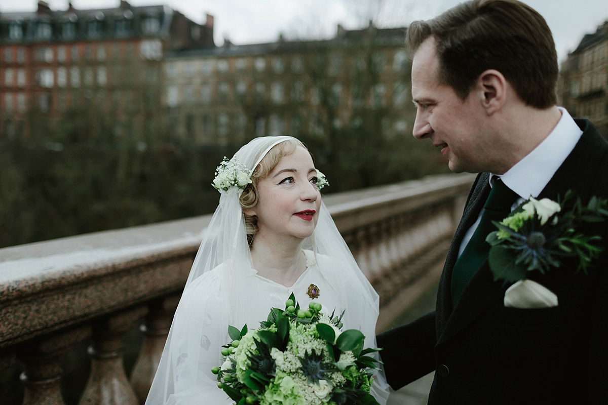 Berenice wore a 1930's vintage wedding dress for her intimate wedding held at home. The couple's ceremony involved a traditional Celtic handfasting. Photography by Rooftop Mosaic.