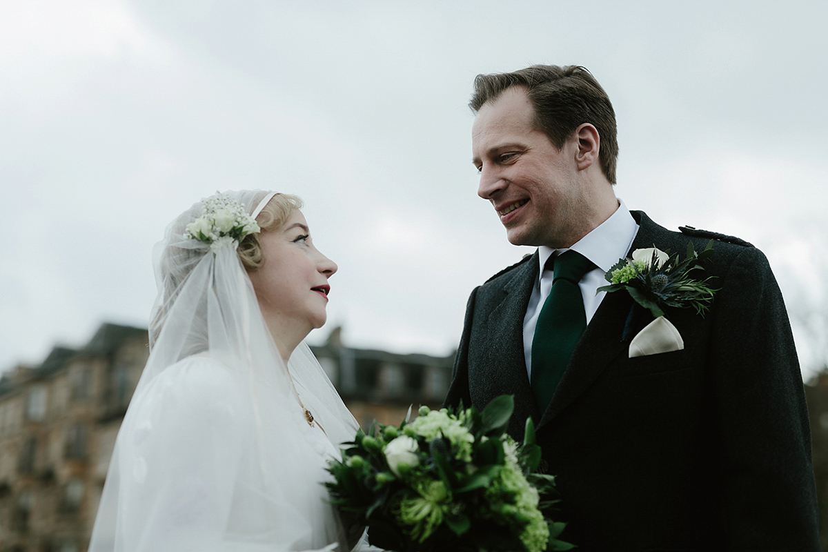 Berenice wore a 1930's vintage wedding dress for her intimate wedding held at home. The couple's ceremony involved a traditional Celtic handfasting. Photography by Rooftop Mosaic.