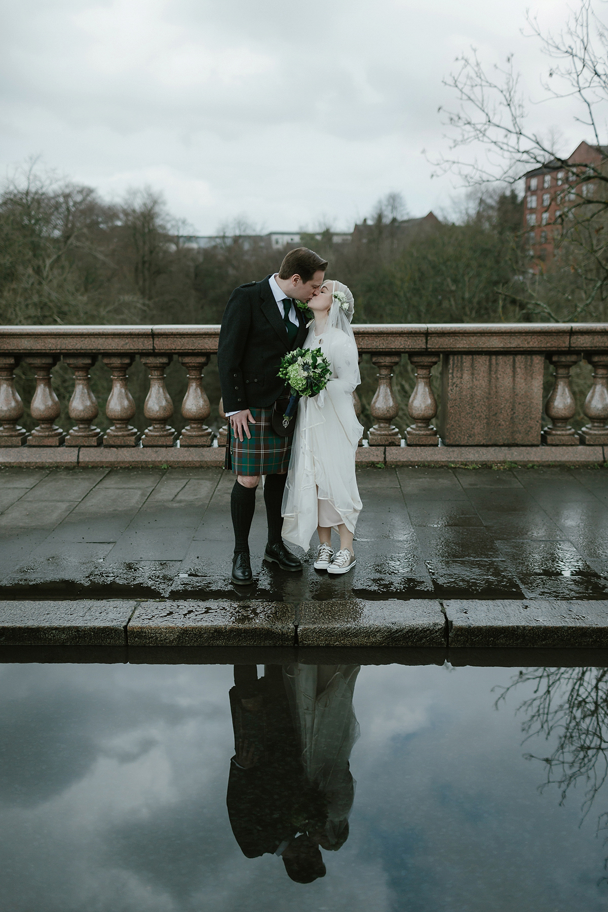 Berenice wore a 1930's vintage wedding dress for her intimate wedding held at home. The couple's ceremony involved a traditional Celtic handfasting. Photography by Rooftop Mosaic.