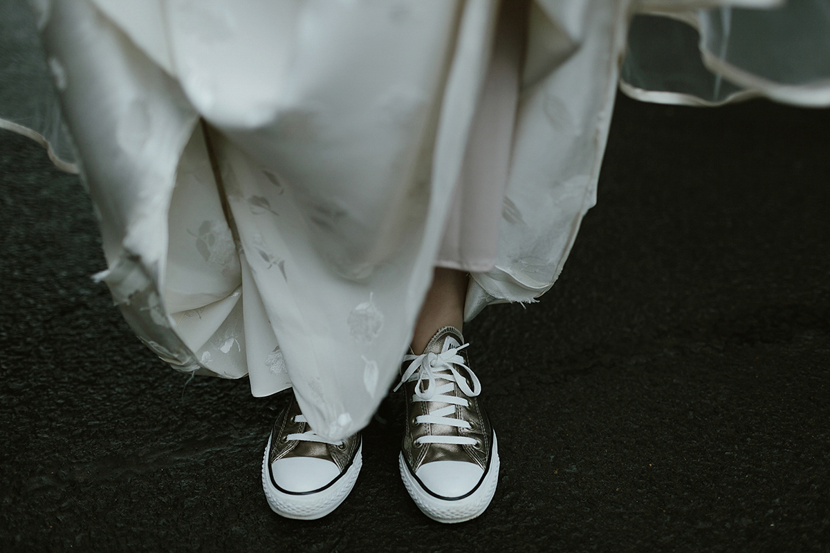 Berenice wore a 1930's vintage wedding dress for her intimate wedding held at home. The couple's ceremony involved a traditional Celtic handfasting. Photography by Rooftop Mosaic.