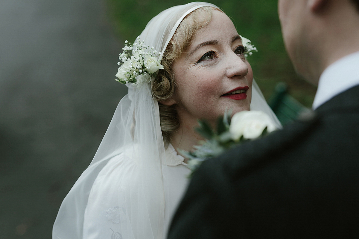 Berenice wore a 1930's vintage wedding dress for her intimate wedding held at home. The couple's ceremony involved a traditional Celtic handfasting. Photography by Rooftop Mosaic.