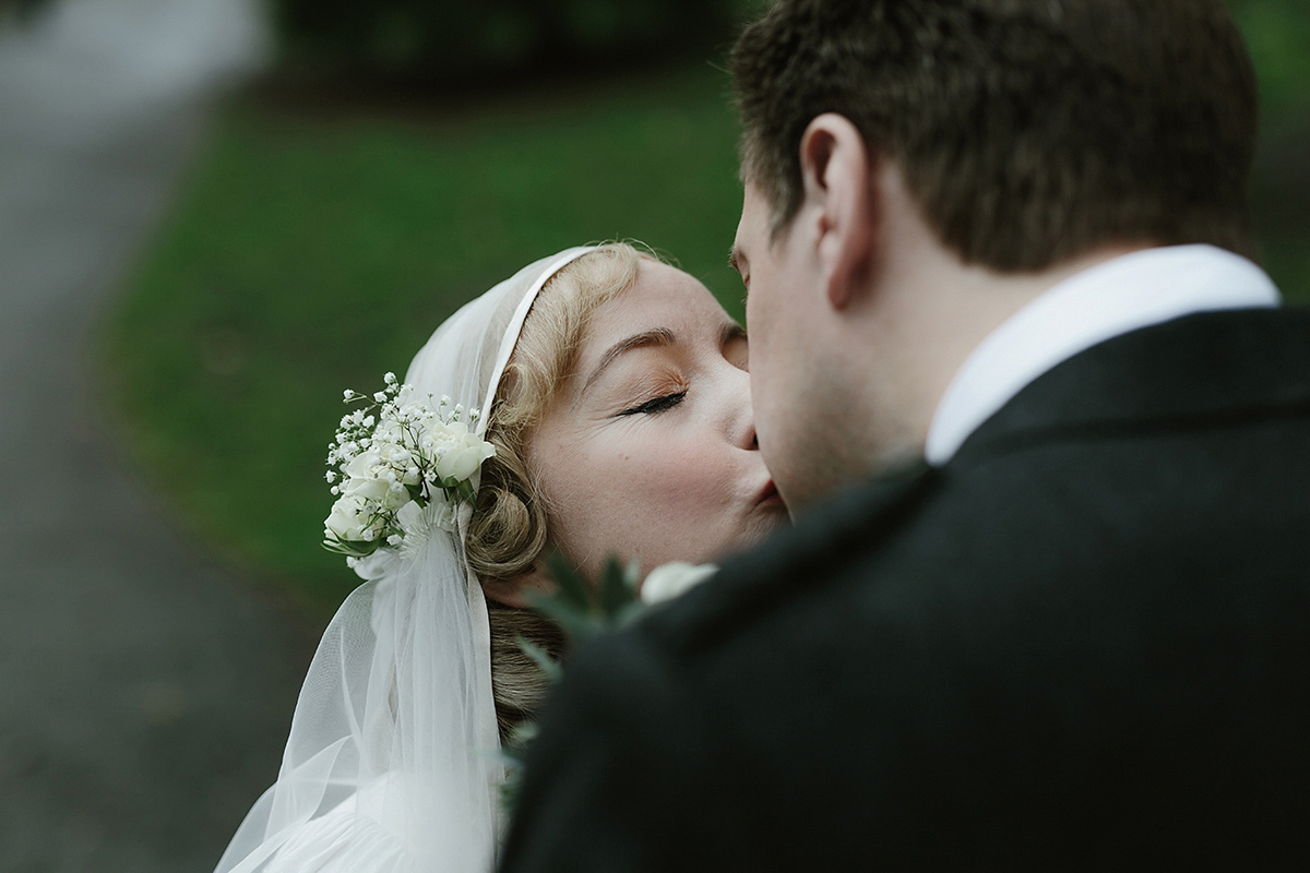 Berenice wore a 1930's vintage wedding dress for her intimate wedding held at home. The couple's ceremony involved a traditional Celtic handfasting. Photography by Rooftop Mosaic.